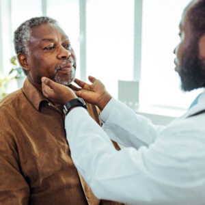 doctor examining senior male patient