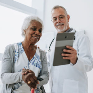 A doctor showing elderly patient something on a tablet at Louisville, KY
